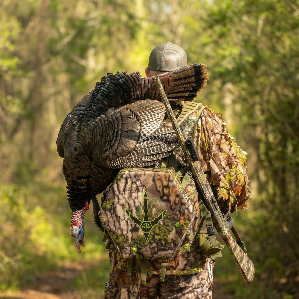 Hunter wearing Beard Buster turkey vest in the spring woods