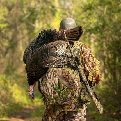 Hunter wearing Beard Buster turkey vest in the spring woods